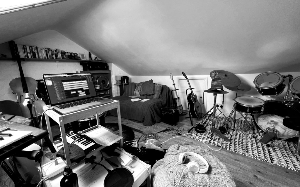 Photo of attic where The Flowers of Despair record. Instruments and recording equipment are present but the band members are not.